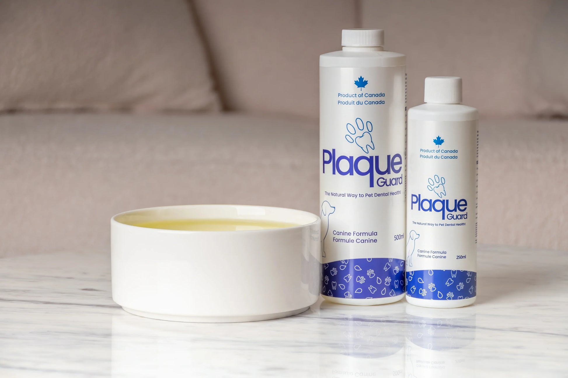 Golden puppy licking Plaque Guard dental water additive bottle with decorative trees behind