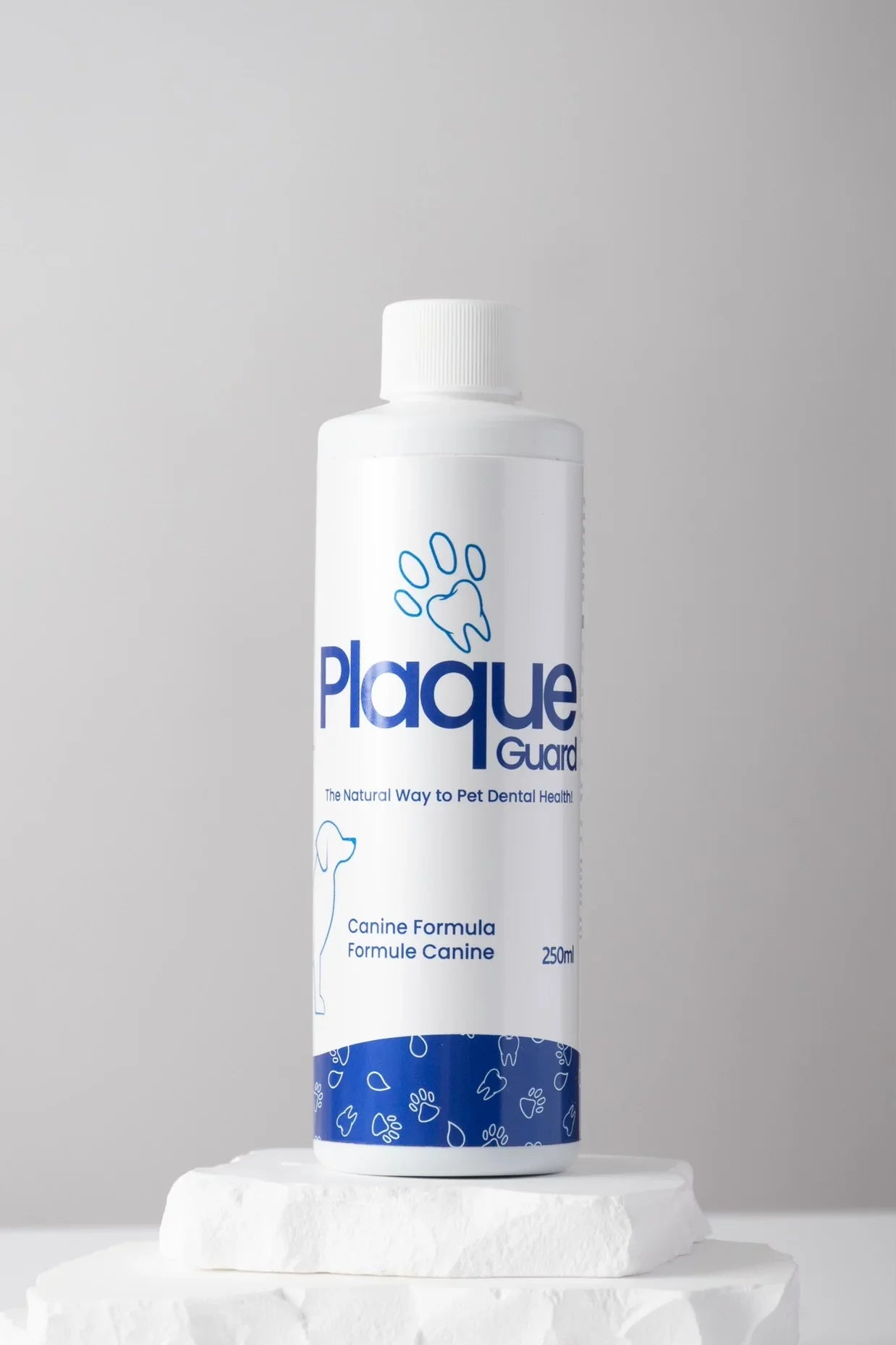 250ml Plaque Guard dental water additive for dogs on white stone platform, neutral background